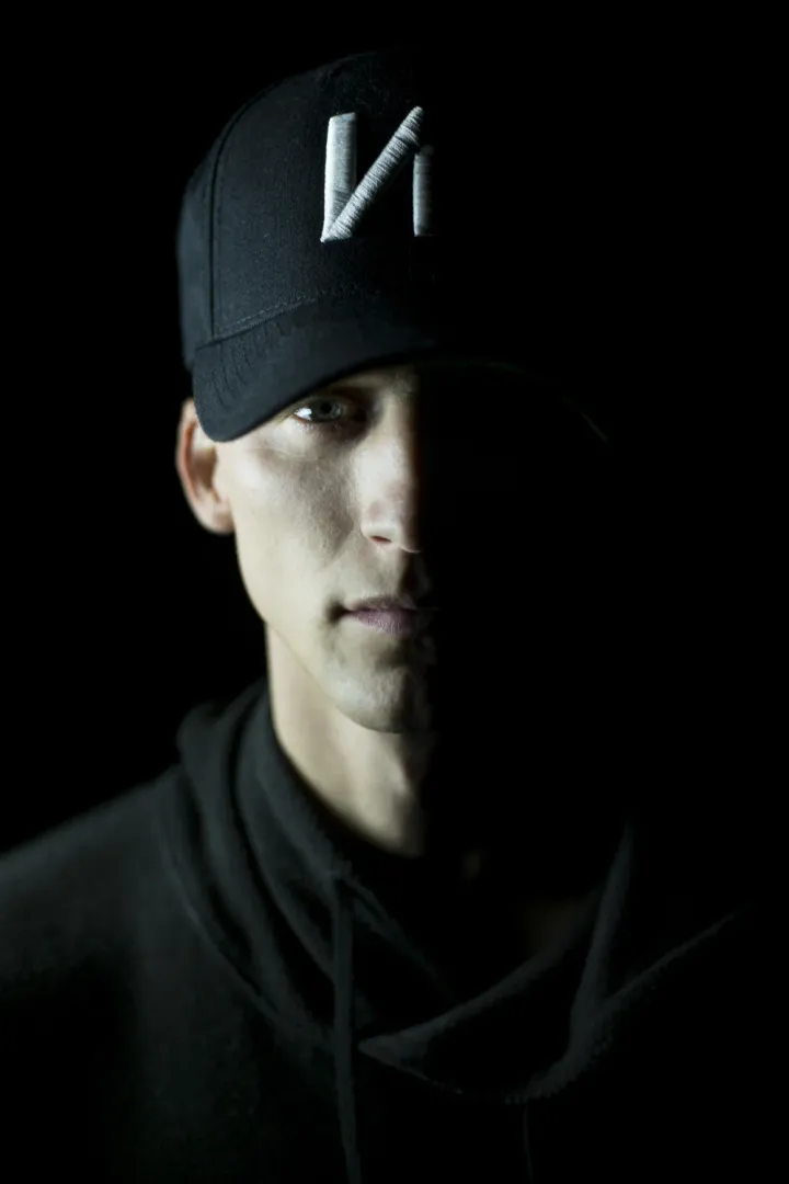 NF in a black cap and hoodie, half his face in shadow, 2016